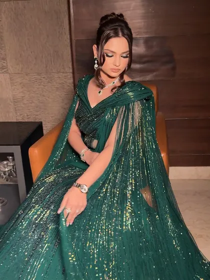 Hollywood glamour meets Indian wedding. This look is all about a dramatic, winged eye with a hint of green, paired with flawless skin and a sophisticated updo.
