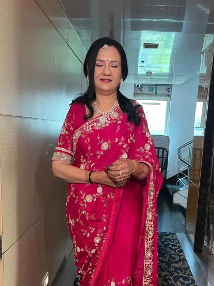 A full-length shot of the client. The makeup and hair are designed to complement her beautiful embroidered saree.