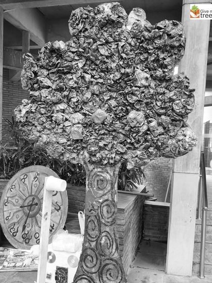 A large tree sculpture made from recycled materials. This art piece is a powerful statement about waste, recycling, and the beauty of nature.