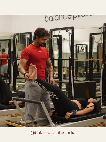 It's all about that personal touch. Here's one of our expert trainers making a hands-on adjustment to ensure perfect form. We're with you every step of the way to make sure you're moving safely and effectively.