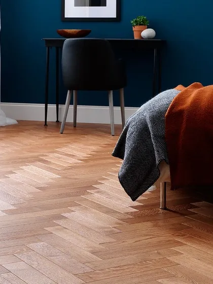 A classic herringbone pattern brings instant elegance to this bedroom. I installed this light oak flooring to create a sense of spaciousness and sophistication. This durable wood flooring design is perfect for adding timeless appeal to any modern home.
