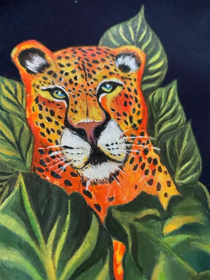 An extreme close-up of the leopard's face. Here you can appreciate the fine details in the eyes, the texture of the nose, and the individual spots that were each painted with care.