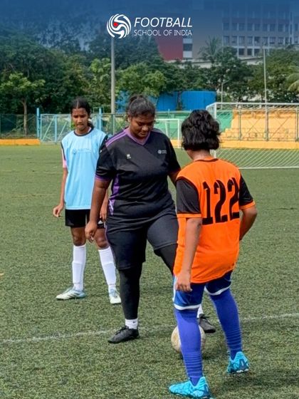 A coach guides a player on her technique, demonstrating our commitment to personalized development.