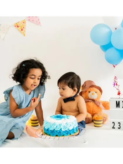 Let's get messy! A cake smash session is all about capturing pure, uninhibited fun. This little one is enjoying his first taste of birthday cake, a moment of sweet chaos and delight.