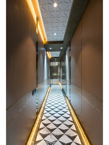 Another view of the hallway, showing the 3D paneled ceiling that adds texture and sophistication. The warm glow from the cove lighting creates an inviting path through the home.