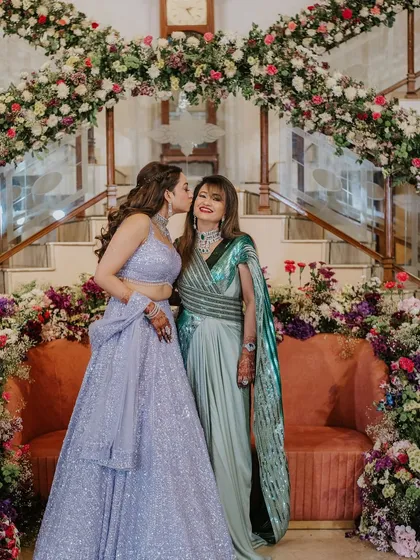 A tender moment between the bride and her mother. The bride's hair looks glamorous and elegant.