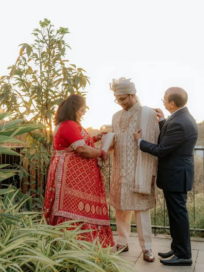 A heartwarming moment as the groom, Sahas, is blessed by his parents before heading to his wedding ceremony.