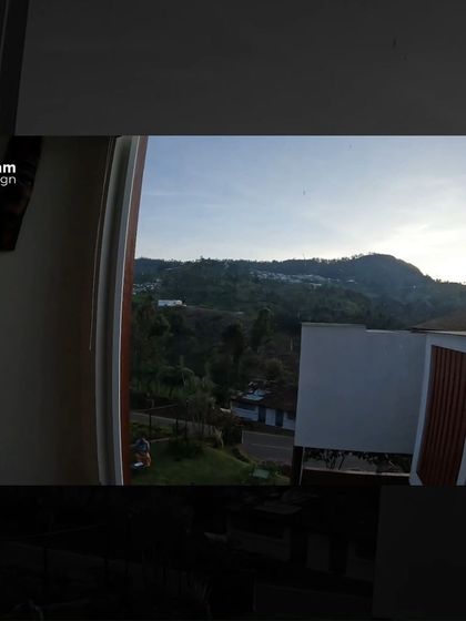 The view from inside, looking out as the sun sets over the hills. The home is designed to be a vantage point, a place to witness the changing light and weather of the mountains.