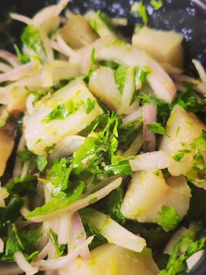 The mix of tender pork, crisp onion, and fragrant herbs makes this Tripura-style salad a delight.