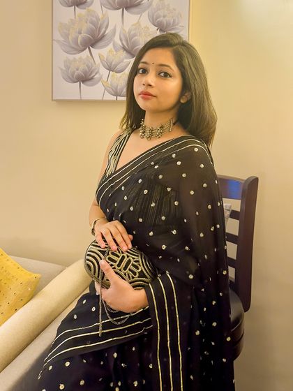 This is my go-to wedding guest look. It's a black mul cotton saree with sequin and gota patti work, which proves that comfortable fabrics can be just as glamorous for formal events.
