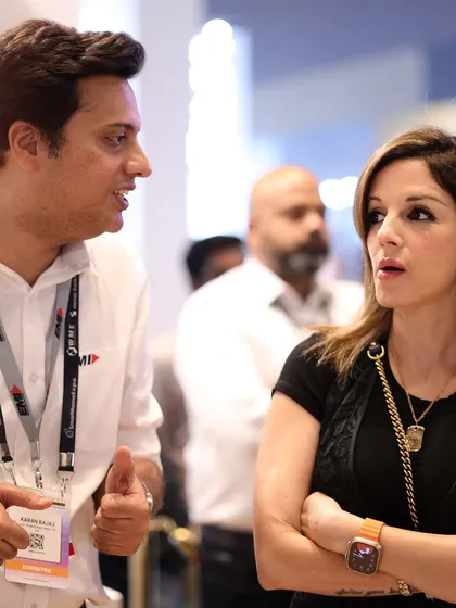 Engaged in a deep conversation, Sussanne Khan discusses smart home solutions with an exhibitor at the Electronics Mart India booth.