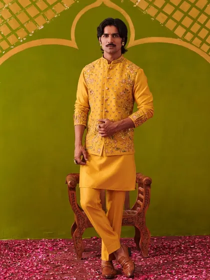 A vibrant yellow kurta and waistcoat set, ideal for a Haldi ceremony or festive celebration. The intricate embroidery on the waistcoat adds a layer of richness, ensuring you look celebratory and stylish.