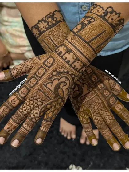 An elegant back-hand design featuring a peacock and elephant. The mix of bold figures and delicate patterns creates a balanced and beautiful composition.