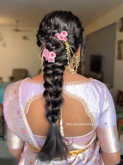 A close up of the textured braid with flowers and gold accessories, showing the beautiful combination of elements.
