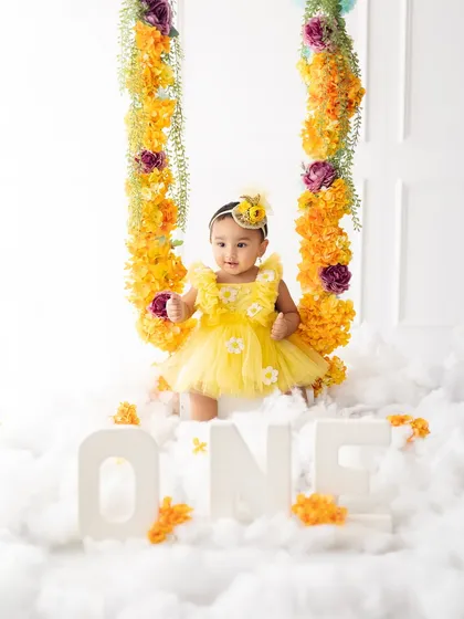 Our floral swing setup with the "ONE" sign, perfect for a beautiful and whimsical first birthday portrait.