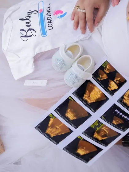 It's all in the details. We love creating these flat-lay announcement photos, combining personal items like your ultrasound scan with cute props like baby shoes and a "Baby Loading" onesie.