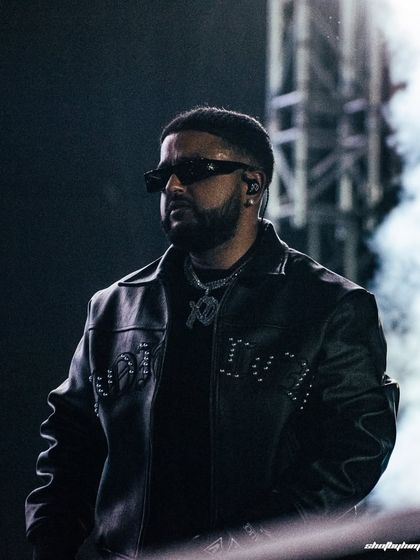 A tight, focused shot of NAV at Rolling Loud Mumbai, surrounded by smoke. This image highlights his confident stage presence and stylish look, capturing the essence of a modern hip-hop star.