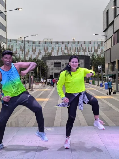 In our element, leading the crowd with high-energy Zumba choreography. My partner instructor and I sync up to bring the best vibes during the "Run for Happiness" marathon warm-up session. This is what fitness with purpose looks like.