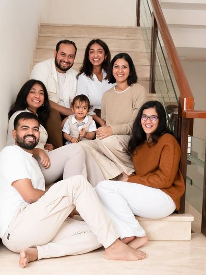 An extended family portrait taken at home on the stairs. At-home sessions are perfect for capturing multiple generations together in a place full of memories.
