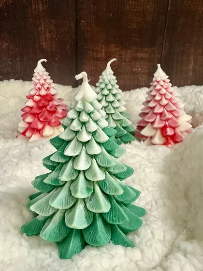Snowy Christmas tree soy candles in festive red and green ombre, ready for the holiday season.