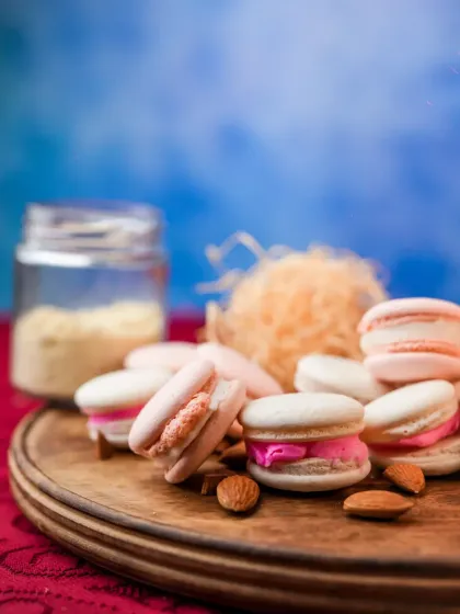 My happy place is a pile of my freshly baked macarons. This shot captures their delicate texture and colorful fillings, surrounded by almonds and sprinkles.