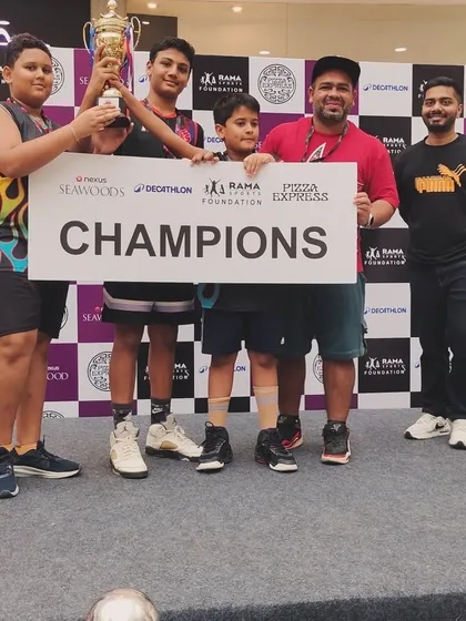 Our U-12 boys team posing with their 'Champions' banner and trophy at the Seawoods mall tournament, a proud moment for the players and coaches.