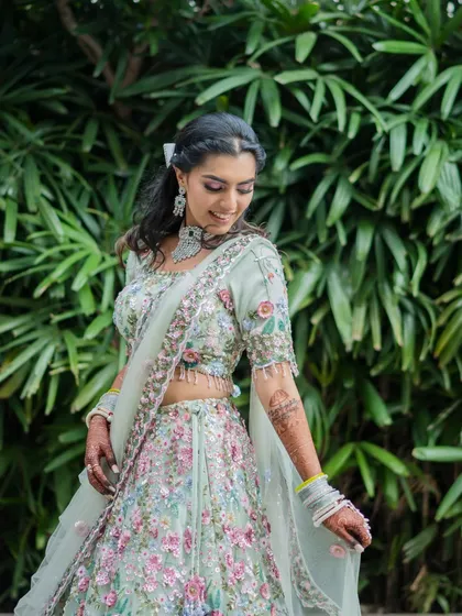 A lovely portrait of the bride at her Mehendi. Her floral-embroidered lehenga and happy smile perfectly match the light and airy feel of the daytime event.