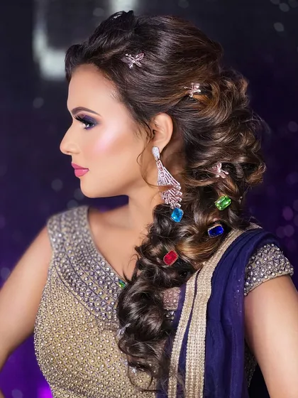 Hairstyling is a crucial part of a complete look. I teach my students how to create intricate and trendy styles like this voluminous messy braid, incorporating colorful accessories to make the final result pop for sangeet nights or cocktail parties.