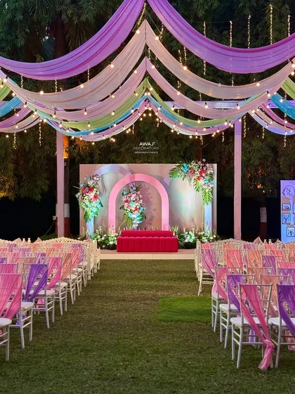 The full view of the pastel stage and guest seating, creating a beautiful and harmonious outdoor setting.