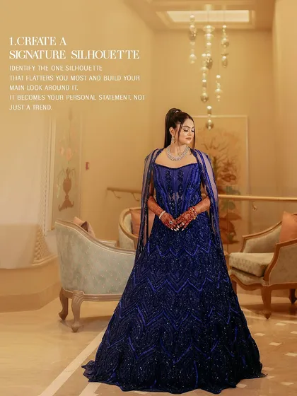 A client looking regal in a fully embellished corset lehenga in active blue, complete with a gracefully draped cape. This is how you create a signature silhouette.