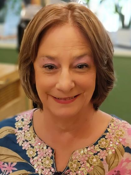 A front-facing view of the finished look. Her smile says it all, glowing with confidence after her hair makeover.