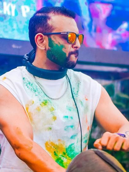 A close-up of me at the console during the Holi party, with colors on my face. I'm always in the middle of the action.