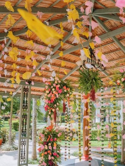 A closer look at the intricate details of the engagement decor, showing the texture of the paper flowers and the variety of blooms used in the arrangements.