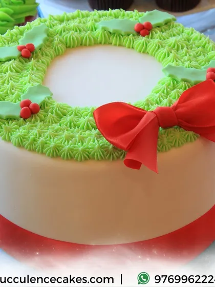 This elegant Christmas Wreath cake is perfect for your holiday table. I use delicate piping techniques to create the green wreath texture, topped with holly details and a beautiful red bow, all completely handcrafted and fondant-free.