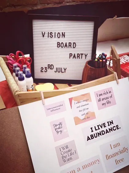 A close-up of the manifestation station. We use powerful affirmations like 'I live in abundance' and 'I will create the life I want' to set the right energy. These are the building blocks for your vision board.