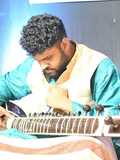 Tuning the sitar during a concert. Proper tuning is crucial for a beautiful performance, and it's one of the first things we will learn.