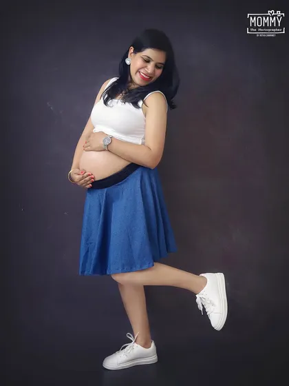Hopping into a new chapter of life. This fun and playful pose in a casual outfit is perfect for showing the happy and excited side of pregnancy.