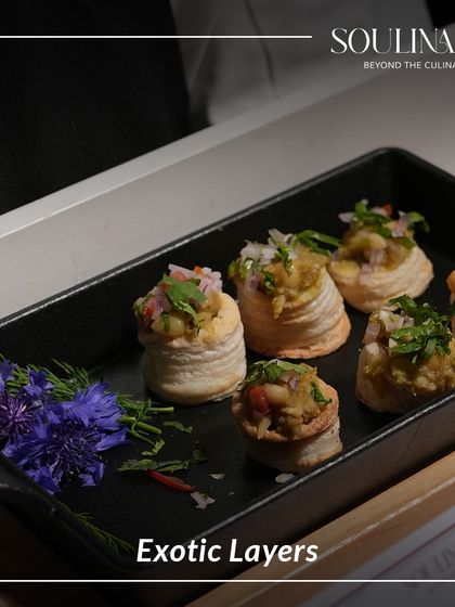 Exotic layers of flavour in a crispy vol-au-vent, garnished with fresh herbs and edible flowers. Each bite is a journey of textures and tastes.