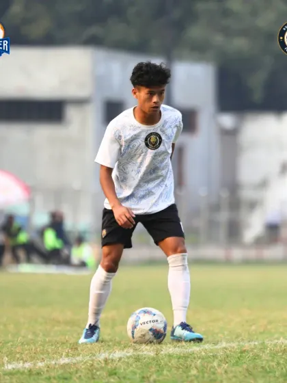 A young player shows composure and skill on the ball, representing the future of our club.