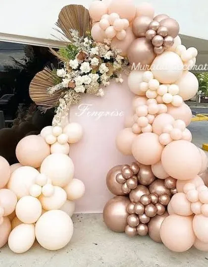 This beautiful boho-themed balloon arrangement was set up outdoors. The soft pastel and rose gold balloons are accented with dried palm leaves and florals, creating a very chic and trendy look.
