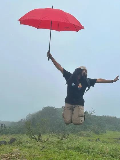 A fun "Mary Poppins" style jump with an umbrella on a misty day at Kumara Parvatha.
