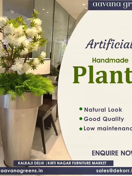 A beautiful handmade plant with white flowers in a large silver planter. This is a sophisticated piece that adds a touch of elegance to any modern interior.