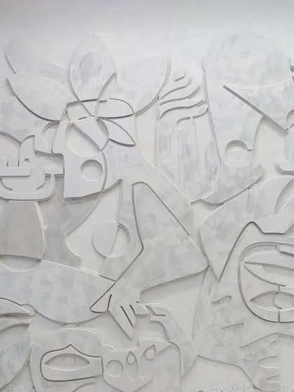 Texture and touch are powerful storytellers. This all-white, 3D wall is a tactile tapestry of abstract figures and symbols, crafted from layers of MDF and plaster. The interplay of light and shadow across the raised forms creates a dynamic, ever-changing artwork that invites you to look closer and trace its lines.