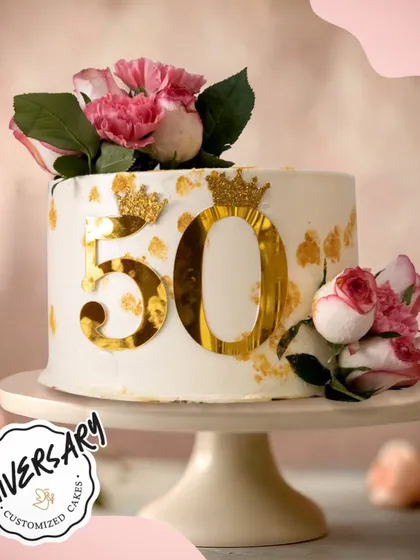 This gorgeous cake celebrates a love that's truly golden. We designed this elegant 50th-anniversary cake with striking gold accents and fresh pink roses for a couple in Greater Kailash, marking their incredible milestone in style.