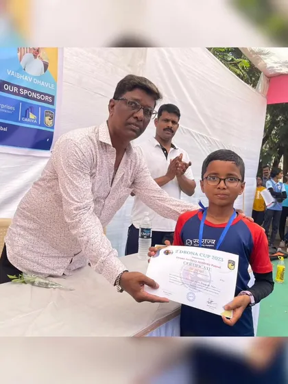 A young participant receives his certificate at the Drona Cup. We believe in recognizing the effort of every archer who competes.