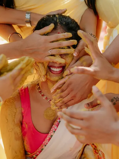This is the pure, uninhibited joy I strive to capture. A candid moment from a Haldi ceremony, where family and friends shower the bride with love and turmeric. These authentic, emotional shots are the heart of my photography style.