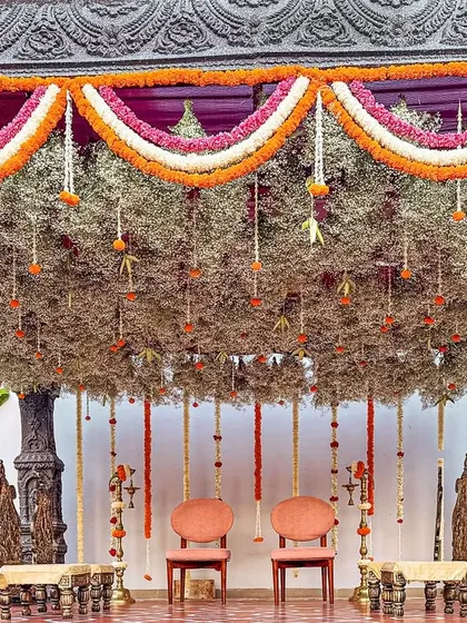 A bride's dream of a temple-style mandap, brought to life with stone-washed textures and a canopy of delicate, hanging florals. This sacred space was designed to feel as if it held generations of blessings.