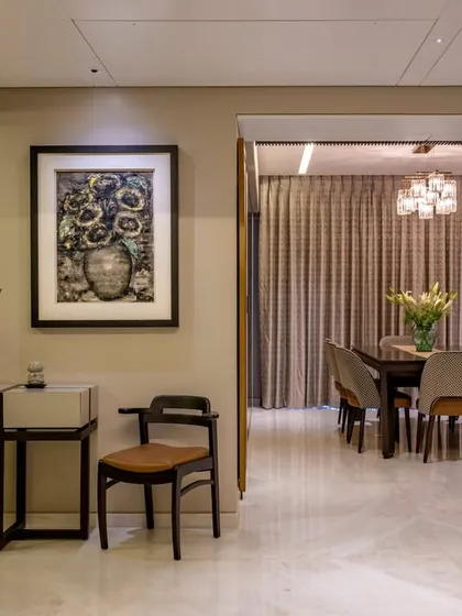 This view shows the transition from the foyer into the formal dining room. We used curated art and a minimalist console table to create a graceful entryway that leads into the main entertaining space.
