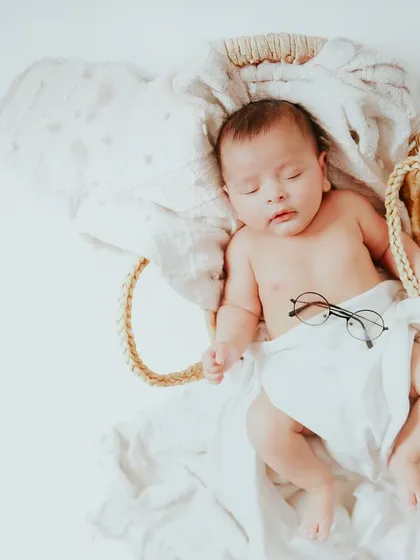 A professional nap model in the making. The tiny glasses add a touch of whimsy to this otherwise minimal and peaceful newborn portrait.