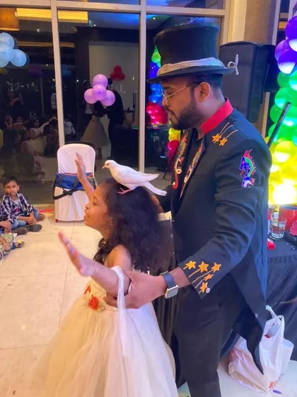 A gentle moment of classic magic as my dove assistant makes a surprise appearance on the birthday girl's head. These timeless illusions bring a sense of pure wonder to children's parties.